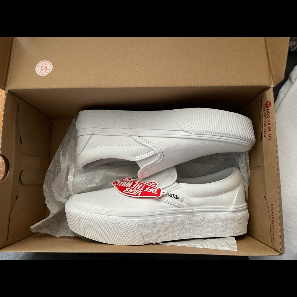 White platform slip on vans